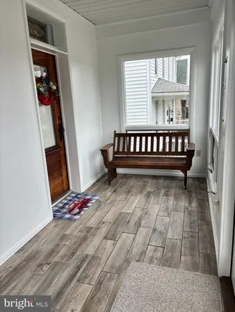 a view of wooden floor with a window and wooden floor