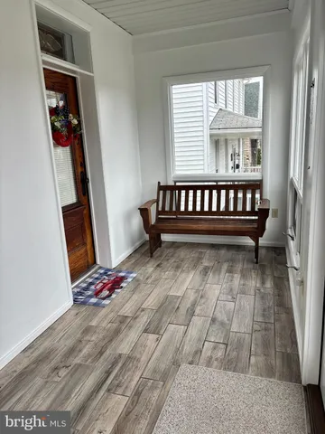 a view of wooden floor with a window and wooden floor
