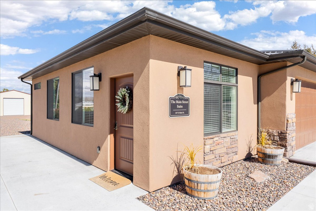 357 East Main Street Enterprise, UT 84725 - Photo 45 of 71 Property entrance featuring stucco siding, an attached garage, and stone siding