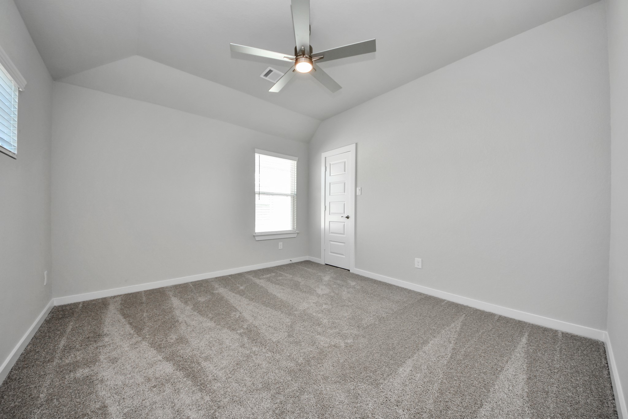 3102 Native Spg Drive Spring, TX 77373 - Photo 38 of 40 Secondary bedroom features plush carpeting, large windows that let in plenty of natural light, bright paint, and spacious closets. Sample photo of completed home with similar floor plan. Actual colors and selections may vary.