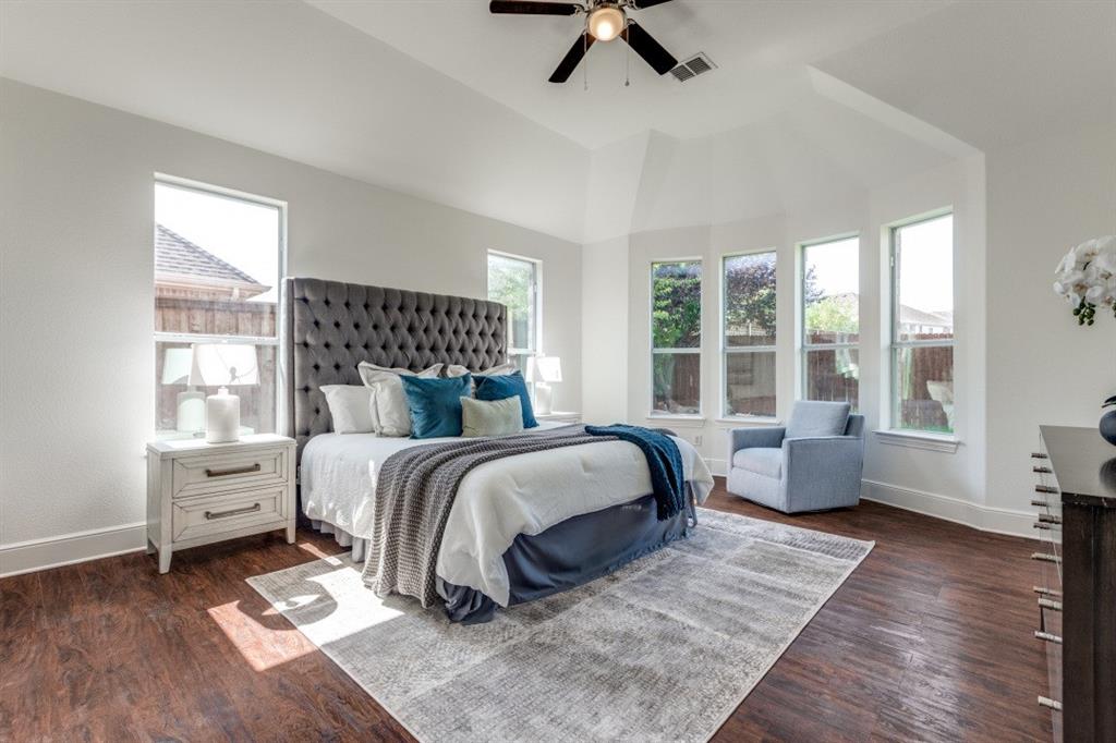 1721 Brookside Drive Prosper, TX 75078 - Photo 8 of 12 a spacious bedroom with a bed and glass window