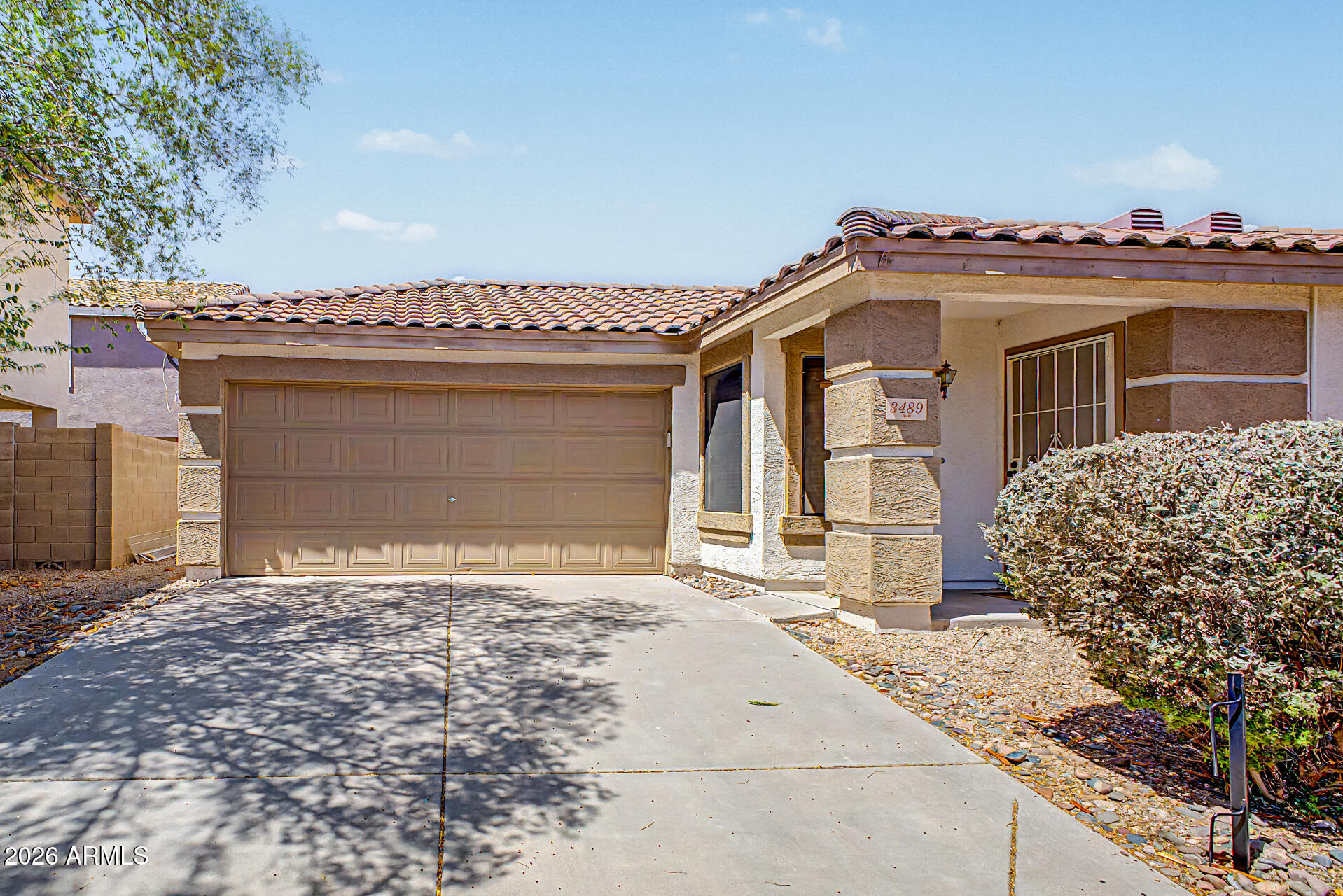3489 South Bowman Road Apache Junction, AZ 85119 - Photo 9 of 24 a front view of a house with a garden