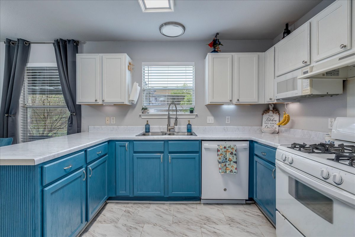 148 Buttercup Way Kyle, TX 78640 - Photo 11 of 30 a kitchen with cabinets appliances and a window