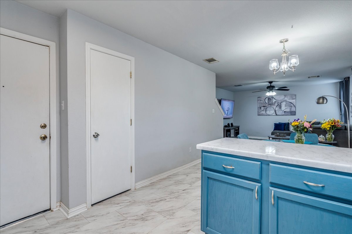 148 Buttercup Way Kyle, TX 78640 - Photo 12 of 30 a room with kitchen island a sink and wooden floor