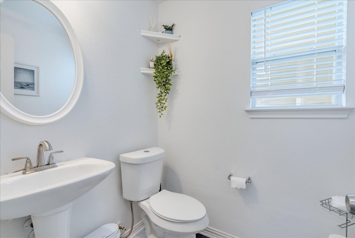 148 Buttercup Way Kyle, TX 78640 - Photo 13 of 30 a bathroom with a toilet a sink and a mirror