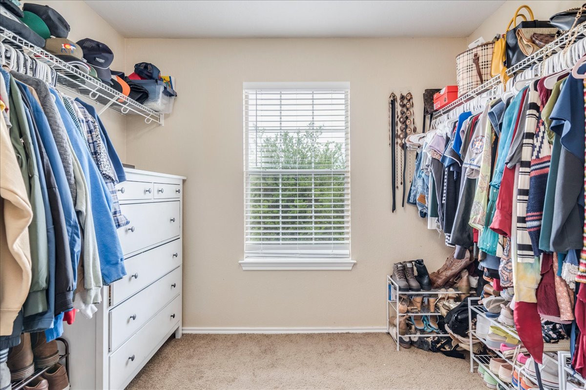 148 Buttercup Way Kyle, TX 78640 - Photo 18 of 30 a view of walk in closet with clothes and shoes