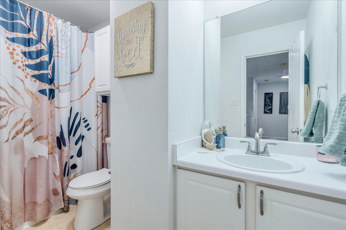 148 Buttercup Way Kyle, TX 78640 - Photo 23 of 30 a bathroom with a sink toilet and shower