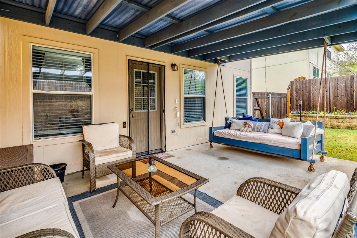 148 Buttercup Way Kyle, TX 78640 - Photo 27 of 30 a outdoor living space with furniture and a large window