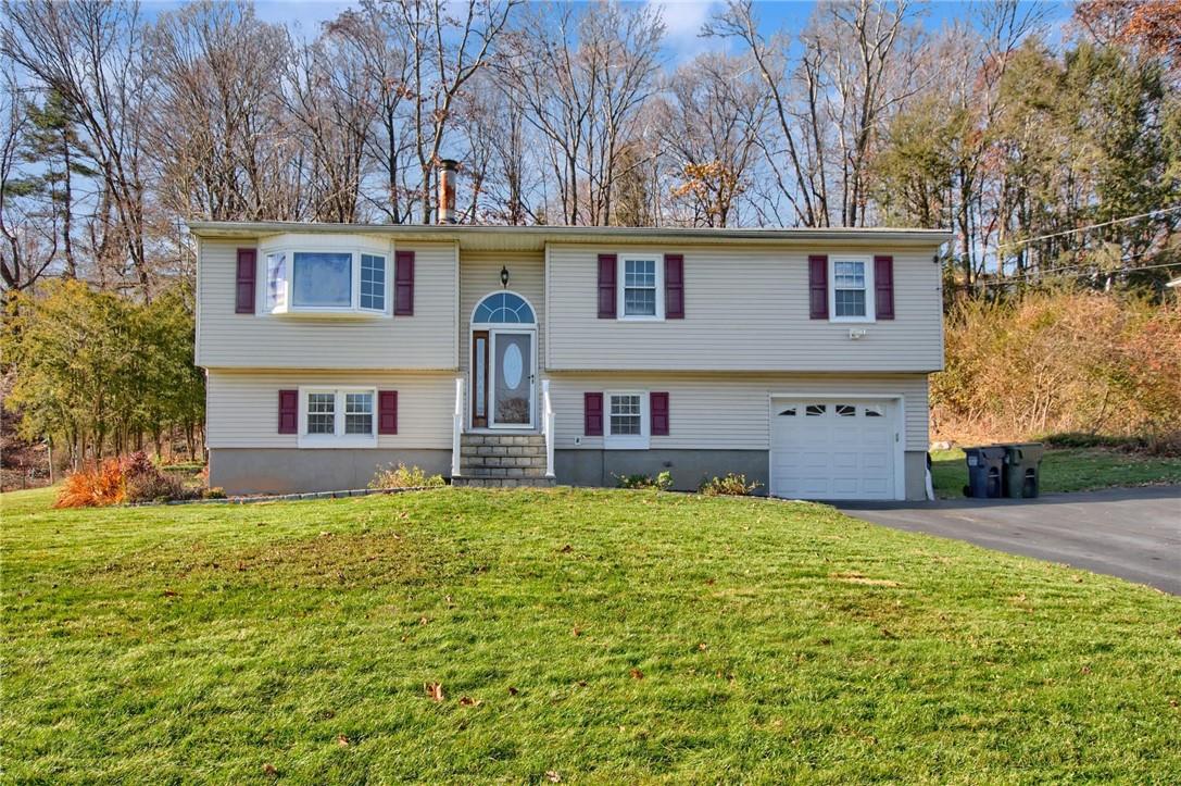 a house that has a large yard with large trees and plants
