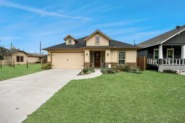 a front view of a house with a yard and porch