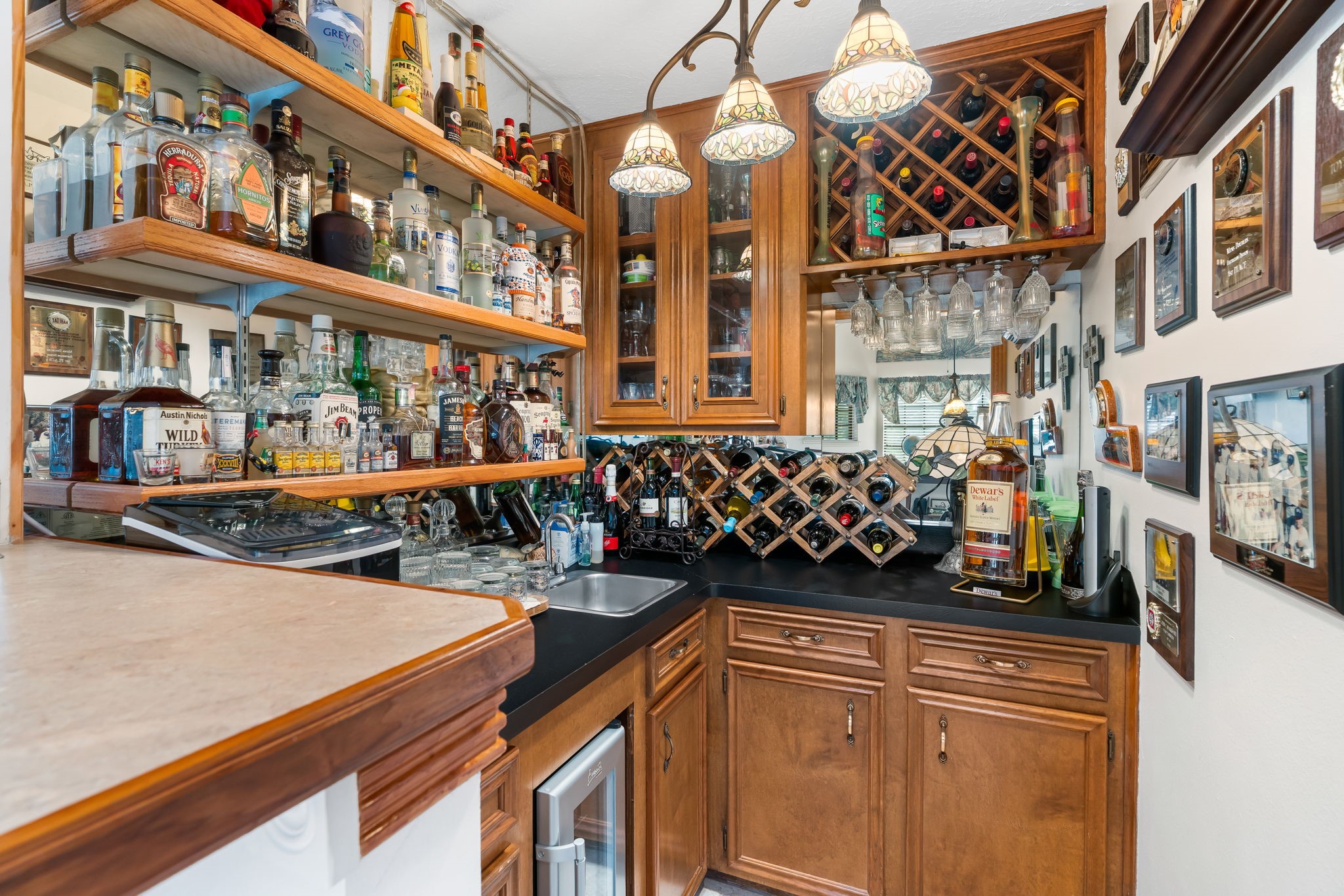 6971 Breezy Point Willis, TX 77318 - Photo 26 of 49 This wet bar is custom designed for plenty of storage as well as a beverage cooler below.