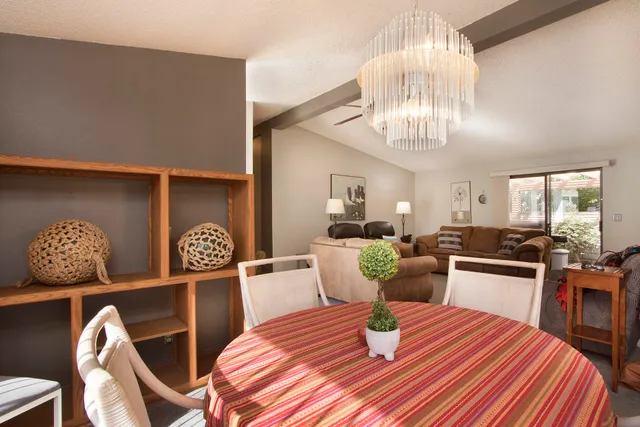 a kitchen with stainless steel appliances kitchen island granite countertop a refrigerator a stove a sink dishwasher with a dining table and chairs