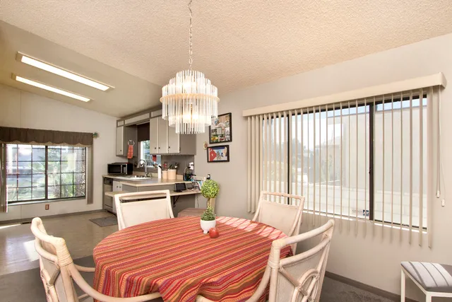 a bedroom with a bed a flat screen tv and a dresser