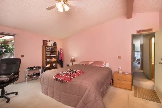 a bedroom with a bed and dresser