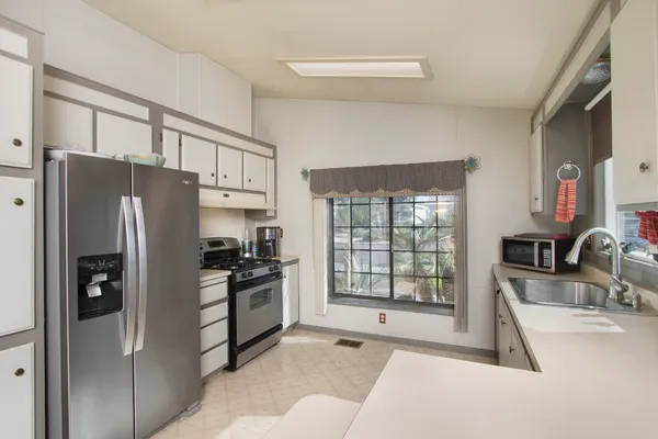 a kitchen with stainless steel appliances a stove a refrigerator and cabinets