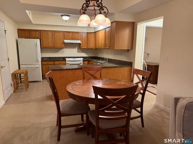 a view of a dining room with furniture and a chandelier
