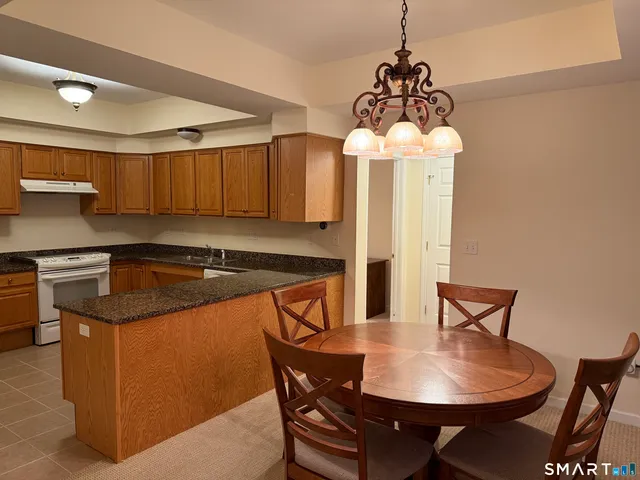 a kitchen with a table chairs and a refrigerator
