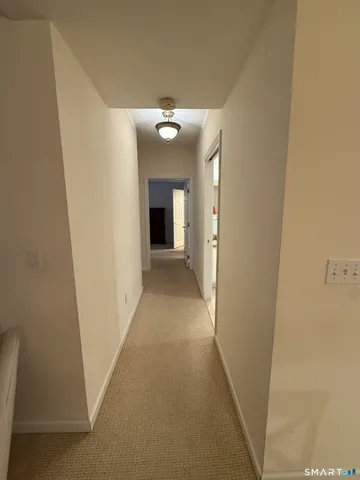 a view of an empty room with a fireplace