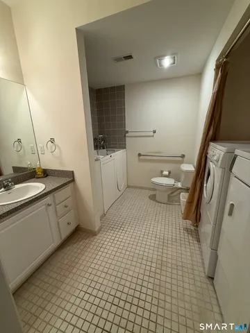 a bathroom with a sink a toilet and mirror