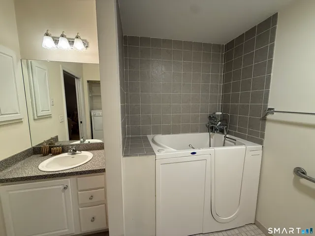 a bathroom with a sink a toilet and mirror