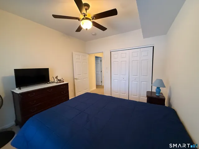 a bedroom with a bed and a television