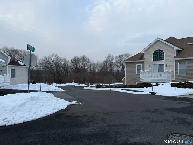 a view of car parked on the side of a street