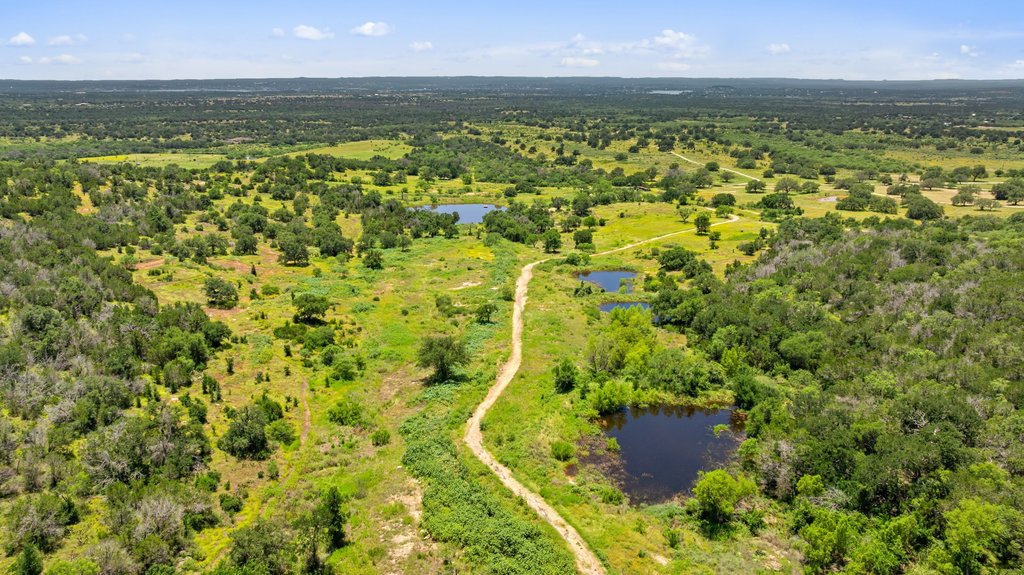 1101 Crider Road Marble Falls, TX 78654 - Photo 5 of 37 Vast natural landscape with ponds and winding paths invites exploration.