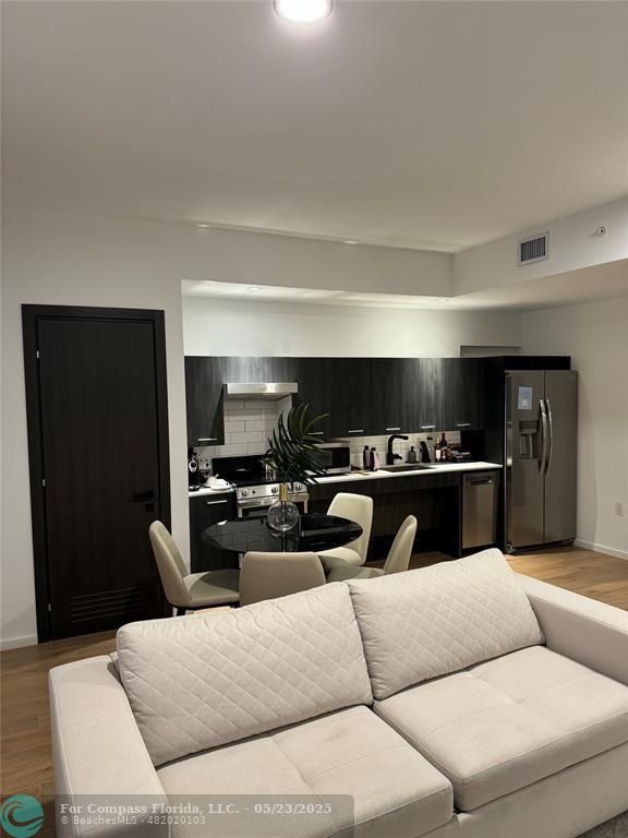 398 Northeast 5th Street, Unit 4015 Miami, FL 33132 - Photo 3 of 9 a living room with furniture and a flat screen tv