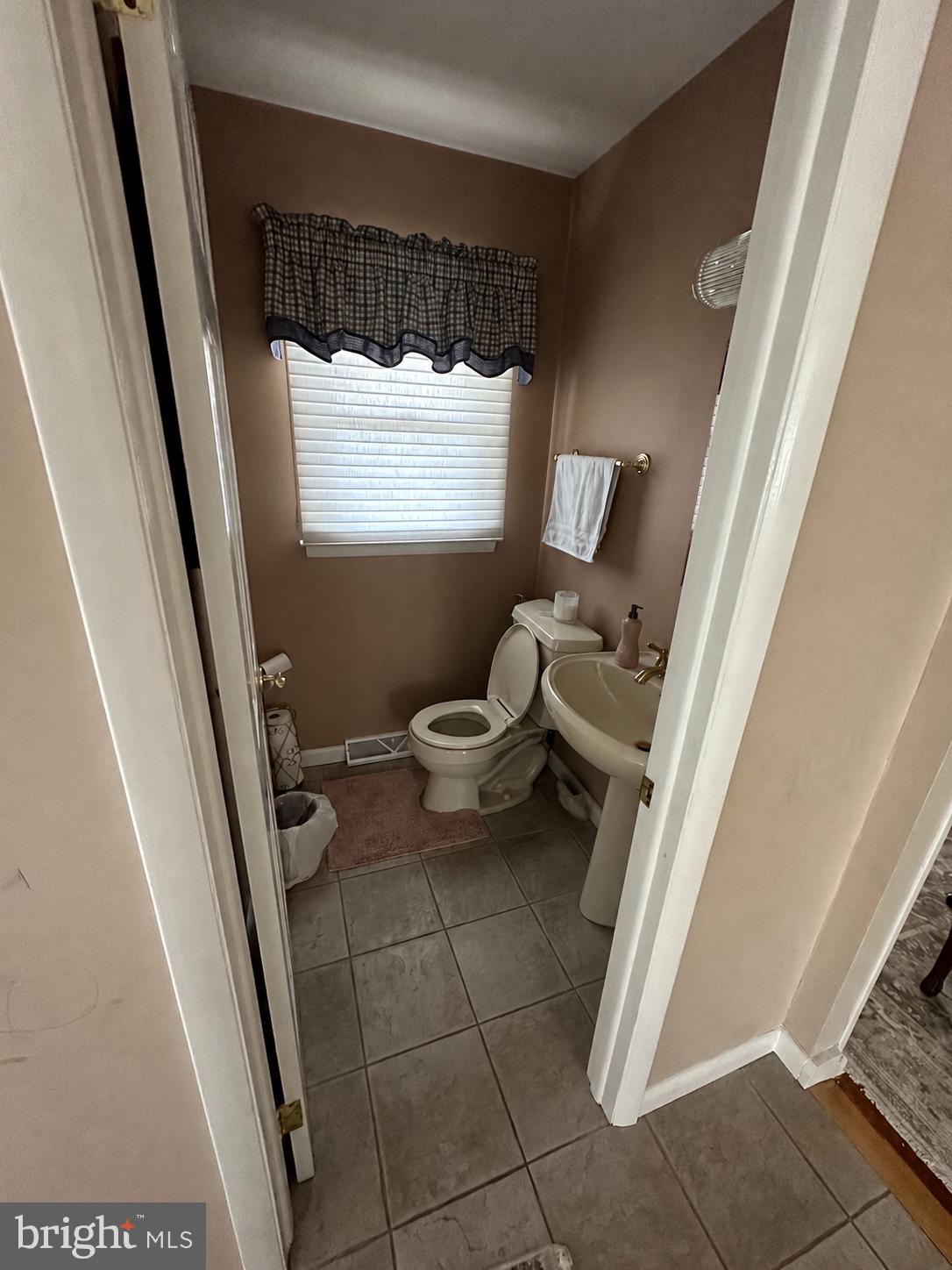 321 Surrey Road Cherry Hill, NJ 08002 - Photo 15 of 24 a bathroom with a toilet and a shower curtain