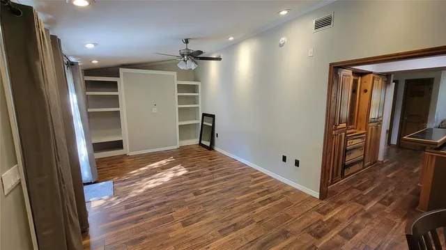 a view of a yard with wooden fence and a large tree