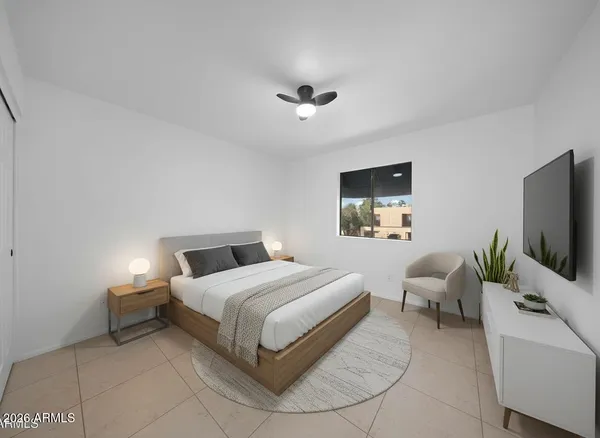 a bedroom with a bed and a flat screen tv