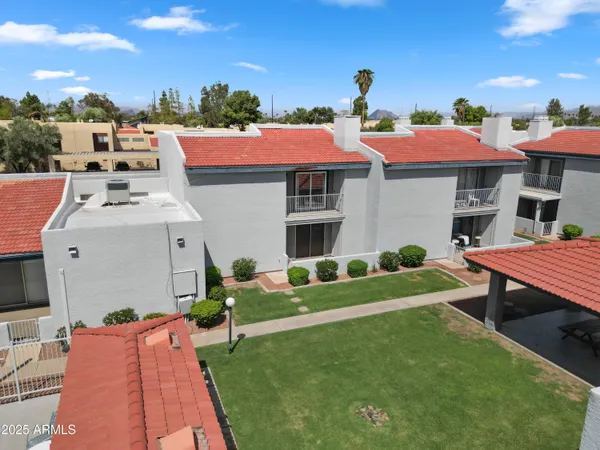 a aerial view of a house with a yard table and chairs