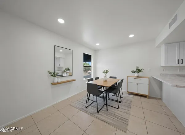 a dining room with a table and chairs
