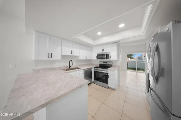 a large kitchen with cabinets and stainless steel appliances