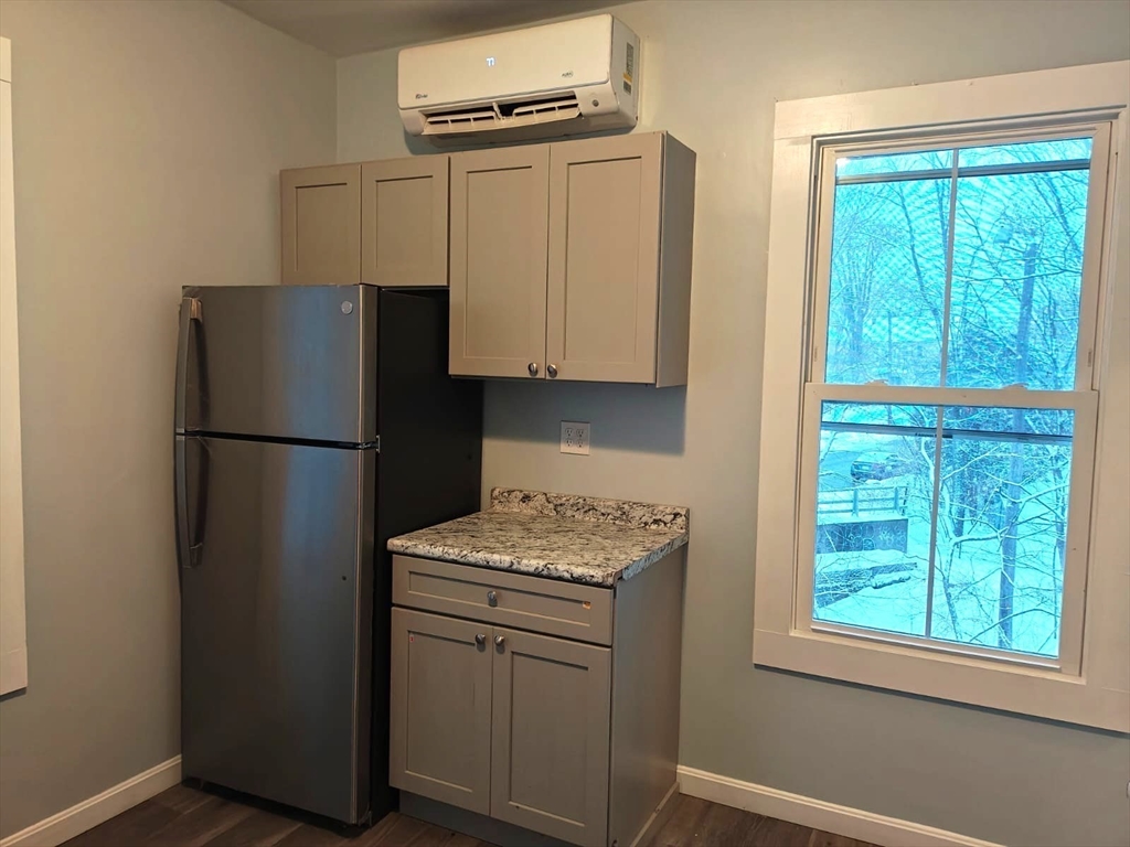 115 Maple Street, Unit 3 Gardner, MA 01440 - Photo 3 of 12 a kitchen with a refrigerator and a sink