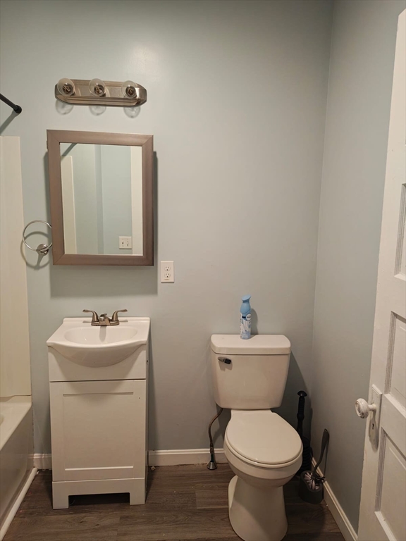 115 Maple Street, Unit 3 Gardner, MA 01440 - Photo 5 of 12 a bathroom with a toilet sink and mirror
