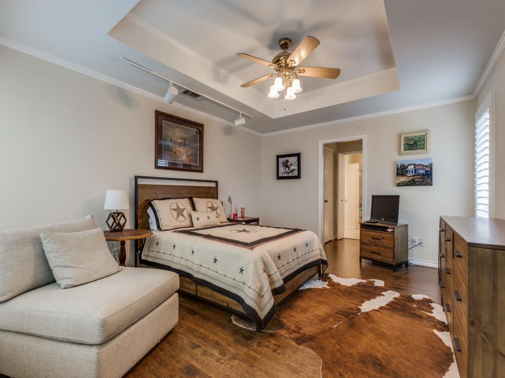 4020 Morman Lane Addison, TX 75001 - Photo 16 of 25 a bedroom with a bed and ceiling fan