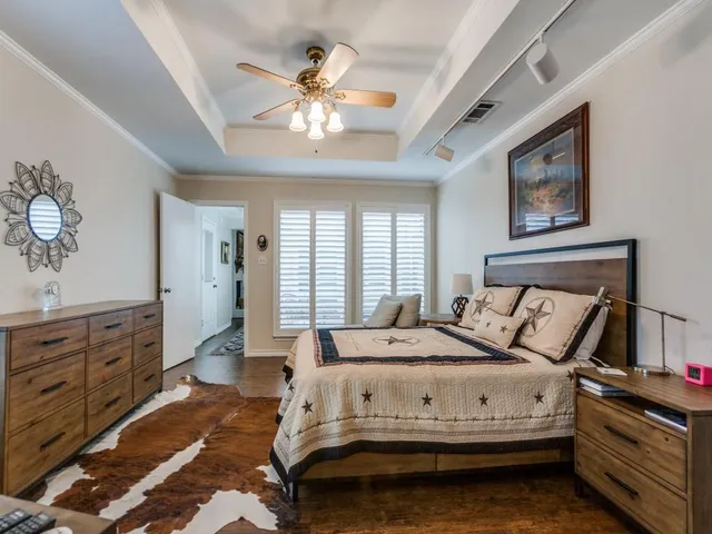 a bedroom with a bed and a chandelier