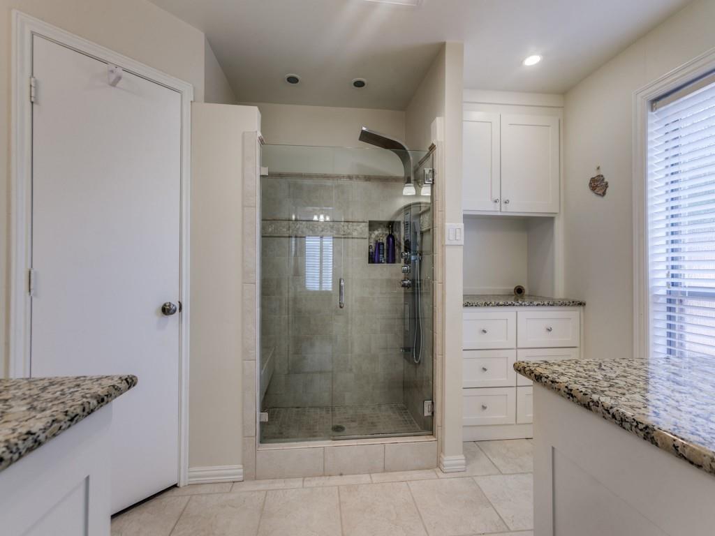 4020 Morman Lane Addison, TX 75001 - Photo 18 of 25 a bathroom with a granite countertop sink a shower and a mirror