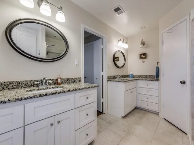 a bathroom with a granite countertop sink mirror and