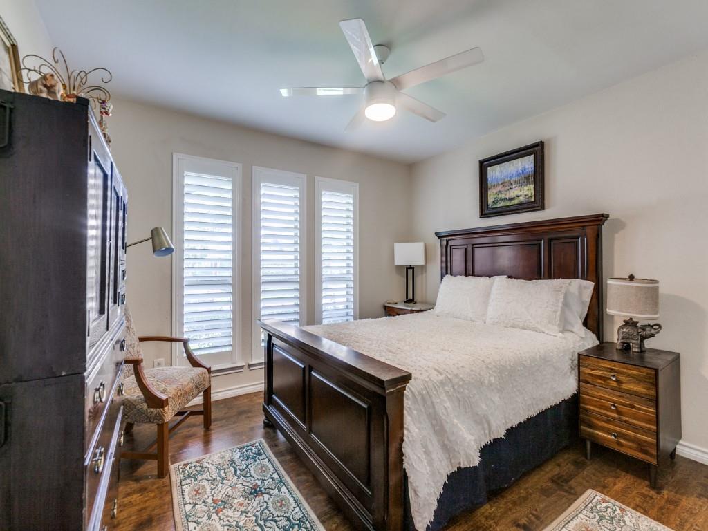 4020 Morman Lane Addison, TX 75001 - Photo 21 of 25 a bedroom with a bed and a chandelier