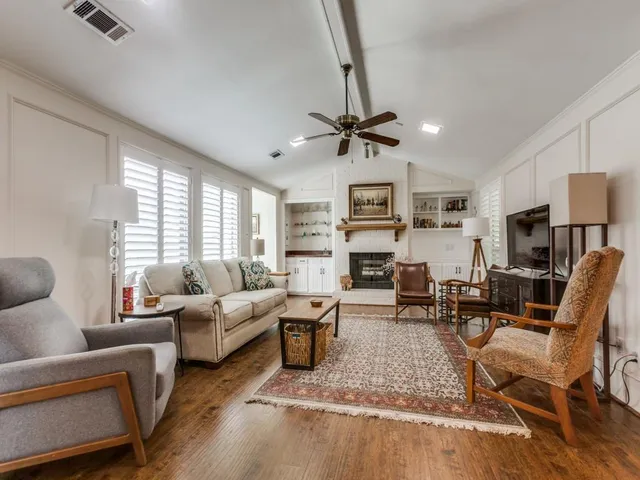 a living room with furniture a fireplace and a window