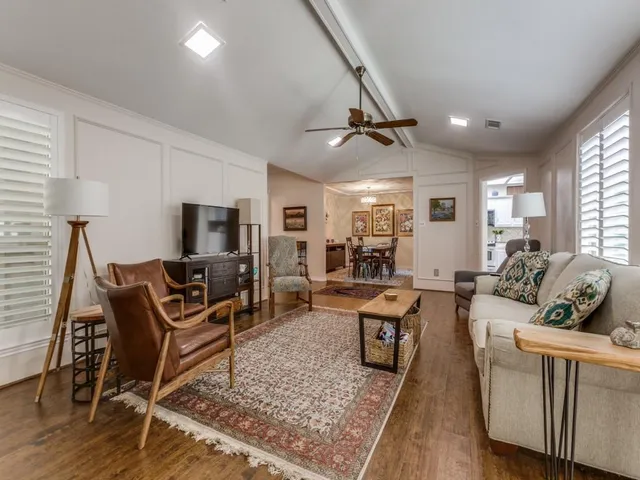 a living room with furniture a rug and a flat screen tv