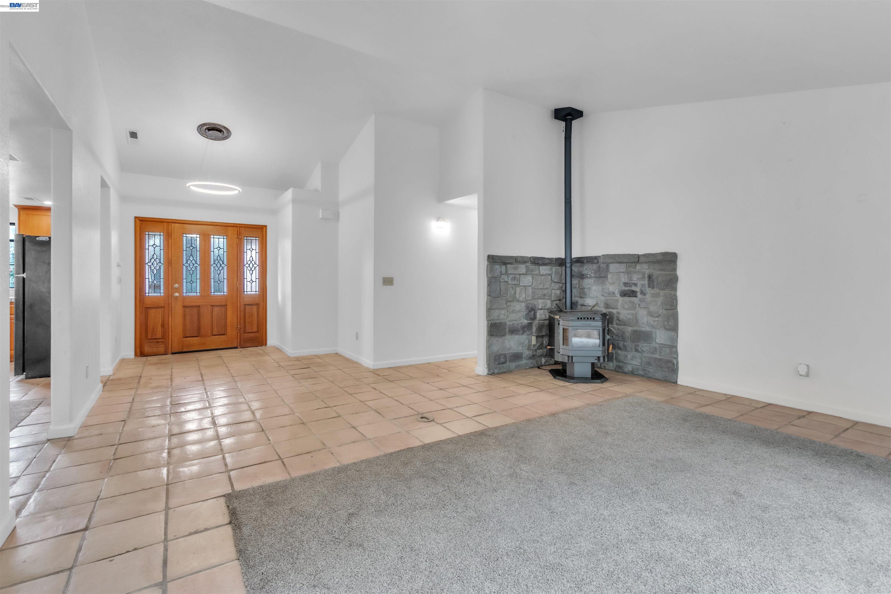 3665 Illinois Avenue Corning, CA 96021 - Photo 12 of 54 a view of an empty room with window and fireplace