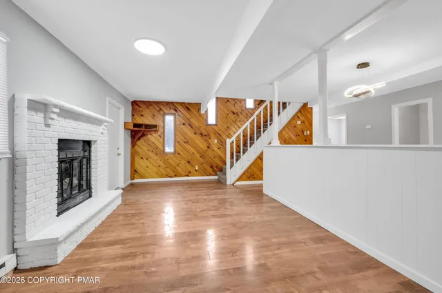 a view of an entryway with wooden floor