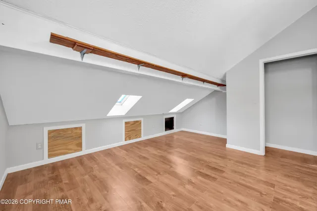 a view of a livingroom with wooden floor and a ceiling fan