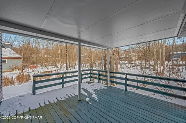 a view of a room with wooden floor and furniture
