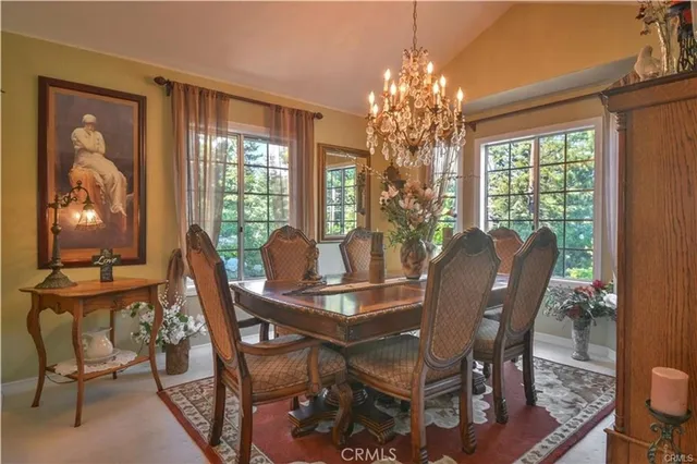 a view of a patio with couches table and chairs and potted plants