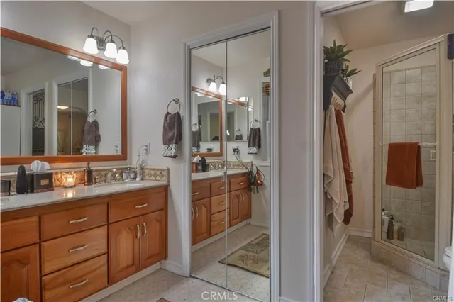 a bathroom with a bathtub shower sink mirror and toilet