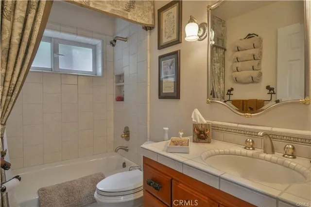 a living room with stainless steel appliances kitchen island granite countertop furniture and a rug